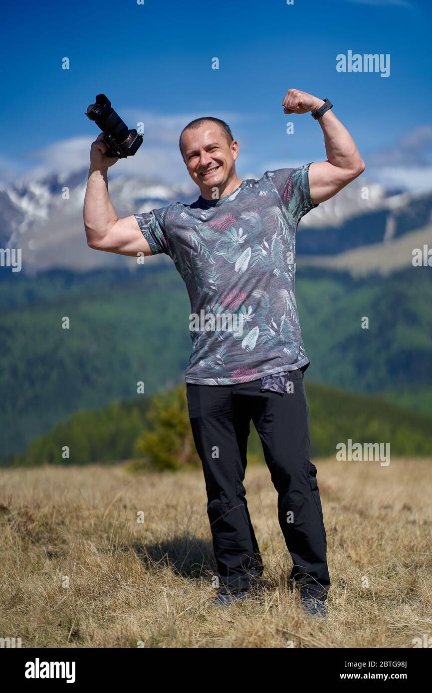 Tourist with camera hiking on a mountain trail Stock Photo - Alamy