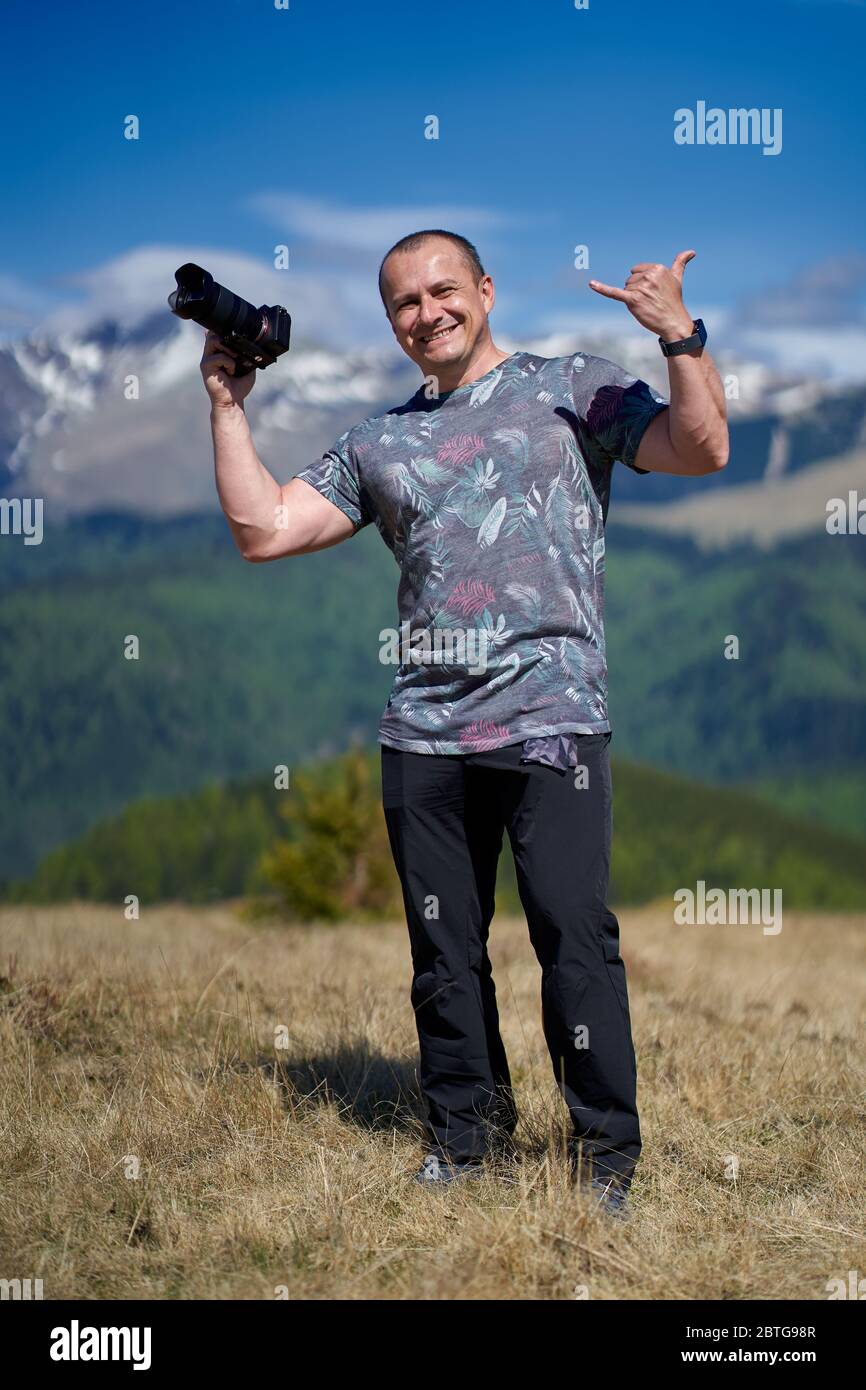 Tourist with camera hiking on a mountain trail Stock Photo - Alamy