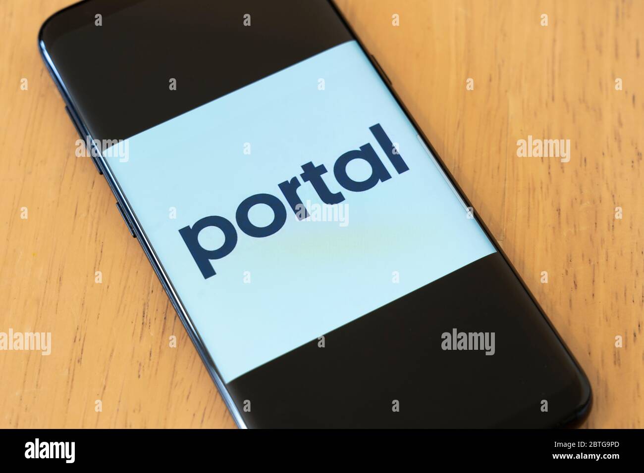 A large logo of the Portal App by Facebook on a cell phone screen that lets you control Portal devices with your smartphone Stock Photo