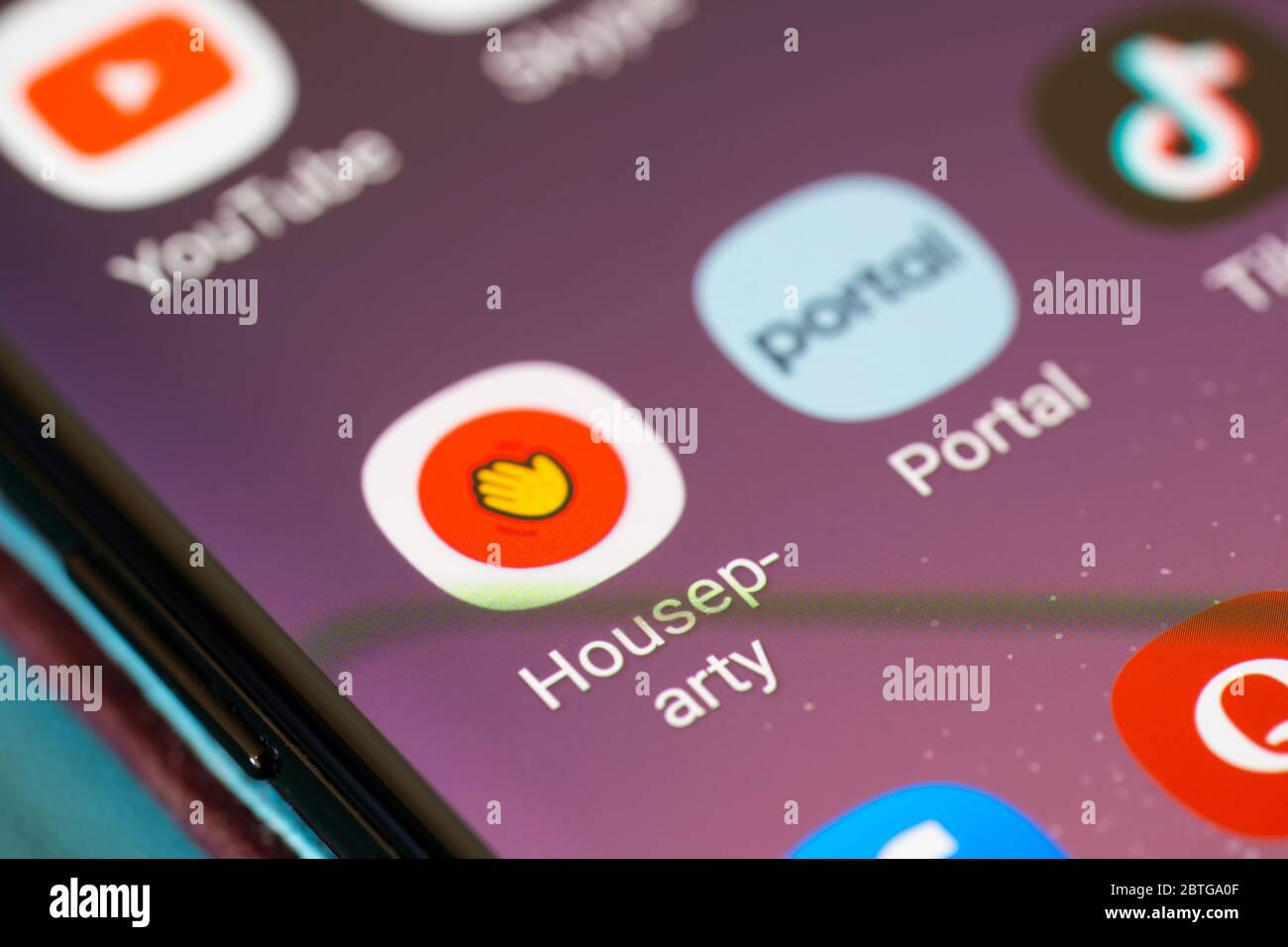 A closeup on a smartphone screen of the application logo for the video calling app Houseparty Stock Photo