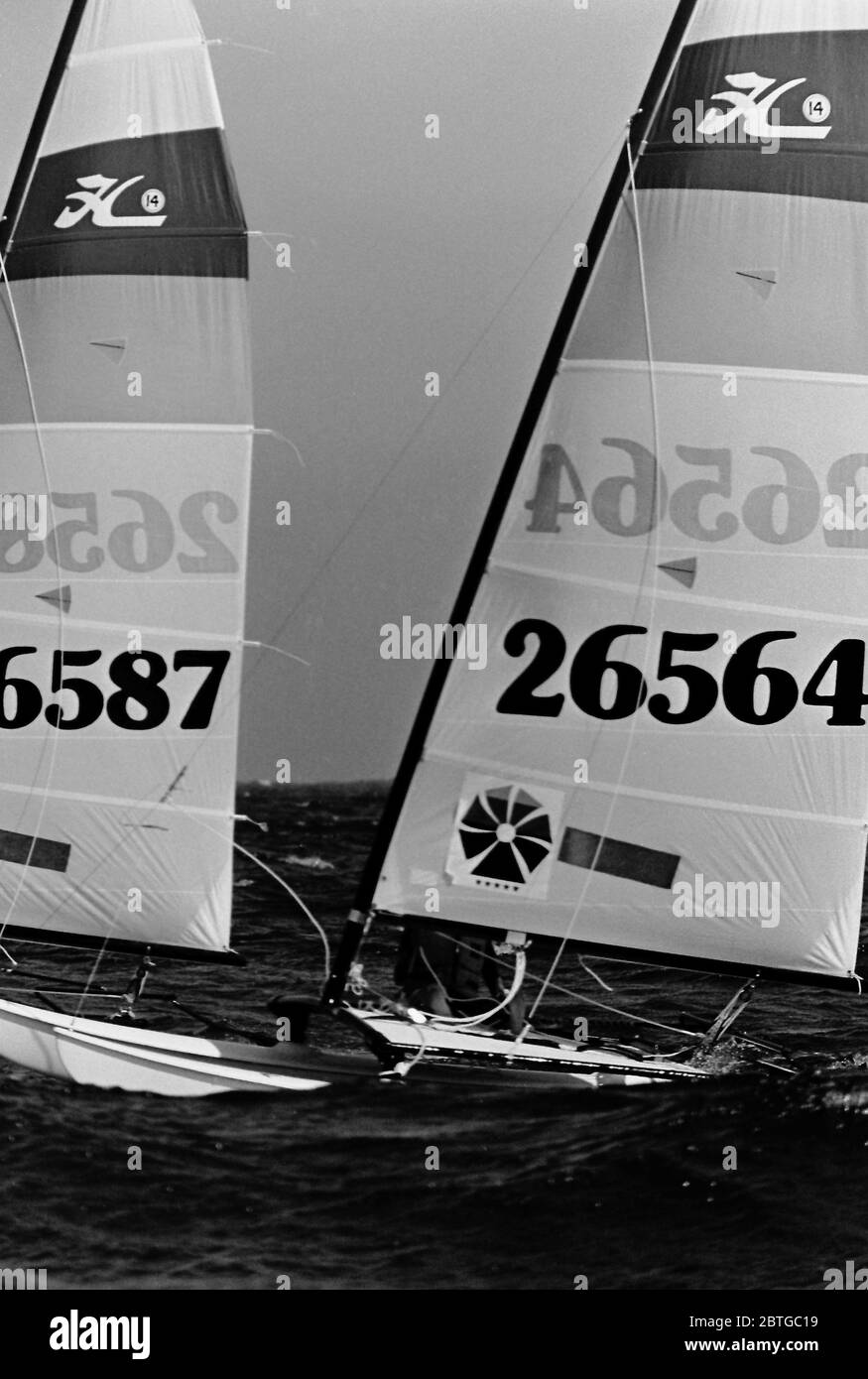 AJAXNETPHOTO. 1977. LAS SALINAS BAY, LANZAROTE, SPAIN. - COMPETITORS RACING IN A STIFF BREEZE AND CHOPPY WATERS IN THE HOBIE CAT 14 WORLD CHAMPIONSHIPS; SAIL NUMBERS 26587, 26564. PHOTO:JONATHAN EASTLAND/AJAX REF:7726091 7 Stock Photo