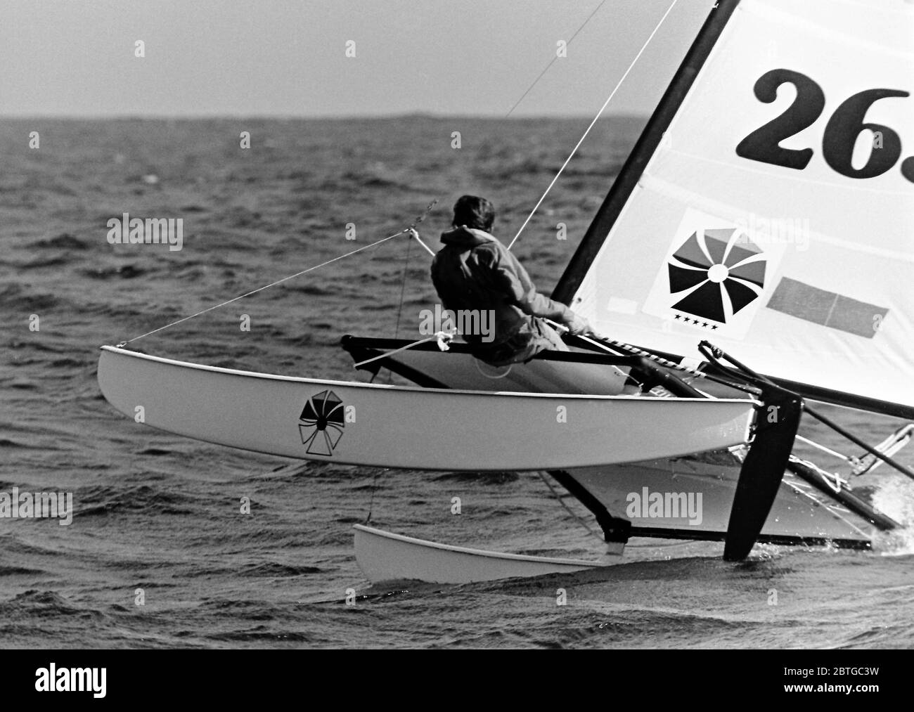 AJAXNETPHOTO. 1977. LAS SALINAS BAY, LANZAROTE, SPAIN. - A COMPETITOR RACING IN A STIFF BREEZE AND CHOPPY WATERS IN THE HOBIE CAT 14 WORLD CHAMPIONSHIPS. PHOTO:JONATHAN EASTLAND/AJAX REF:7726091 87 Stock Photo