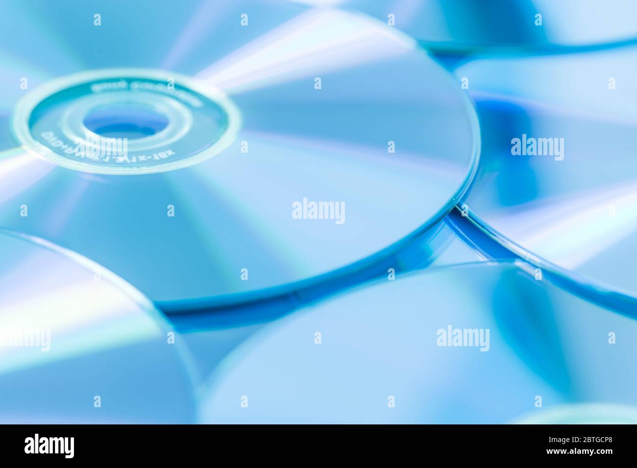 Stack of CD or DVD in blue tone as background. Soft focus. Stock Photo