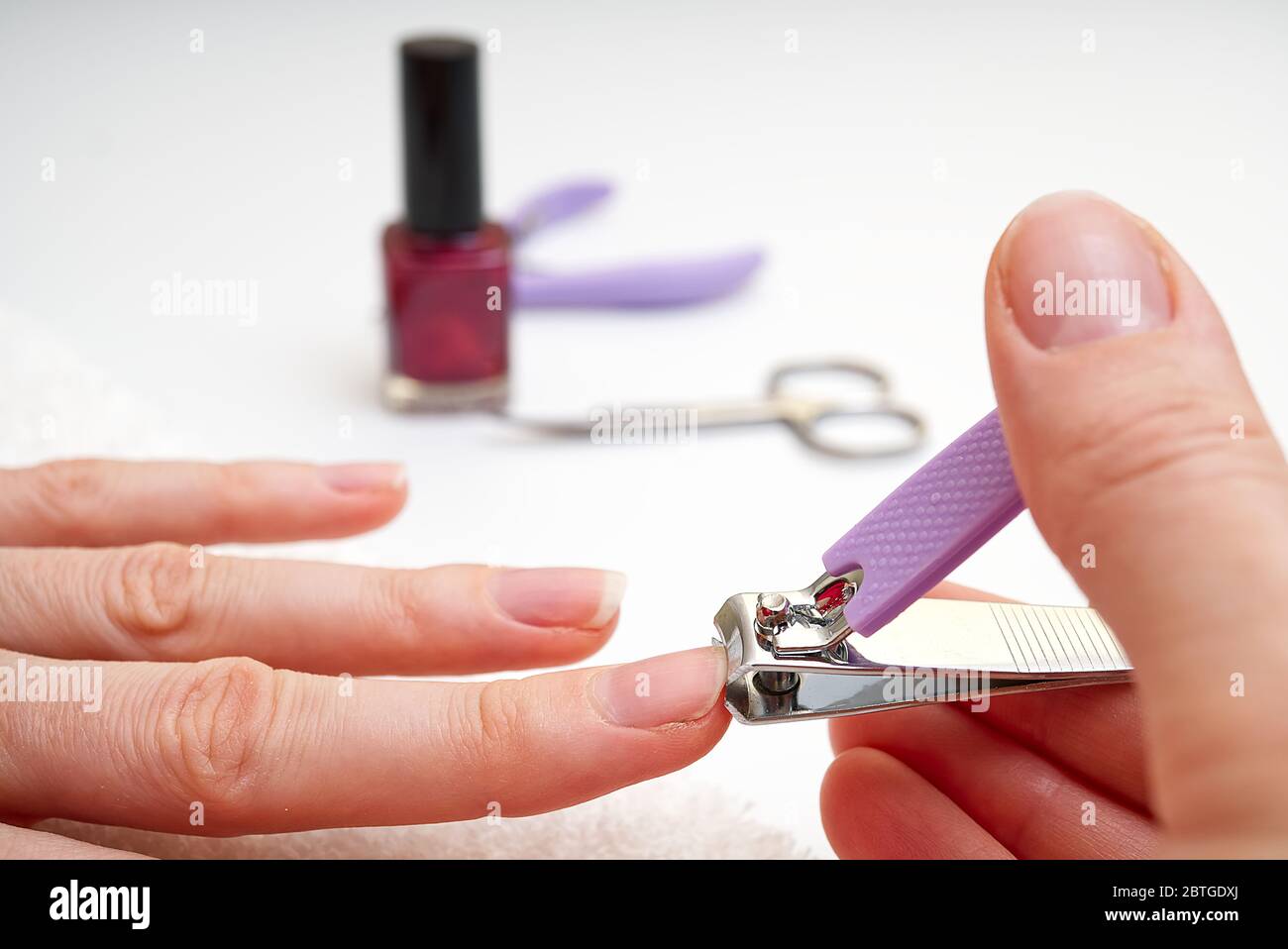 Woman Clipping Nail s with Forceps. Female cuts his nails on a white background with tweezers for nails. manicure procedures yourself at home Stock Photo - Alamy Woman Clipping Nail s with Forceps. Female cuts his nails on a white background with tweezers for nails. manicure procedures yourself at home Stock Photo - Alamy