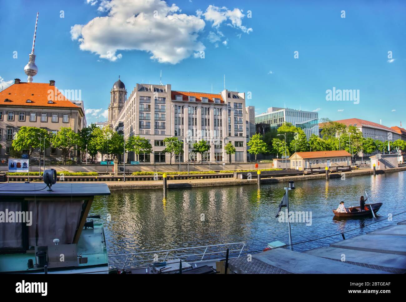 Near the historic harbor in central Berlin, a couple is boating across the Spree canal. Stock Photo