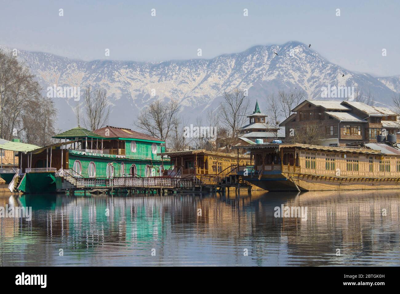 Houseboats on Dal Lake in Srinagar, summer capital of Jammu and Kashmir with Himalayan Mountains