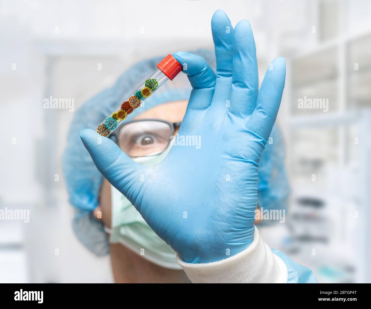 The doctor hold test tube with a collect of virus inside, focus on a hand, blurred face. Research of a dangerous microorganism. Stock Photo