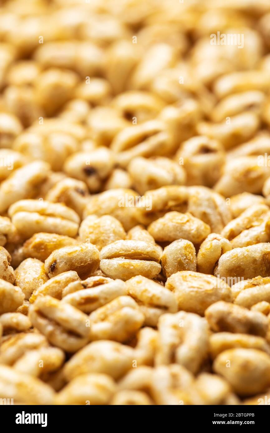 Puffed wheat covered with honey. Pattern of healthy cereals. Stock Photo