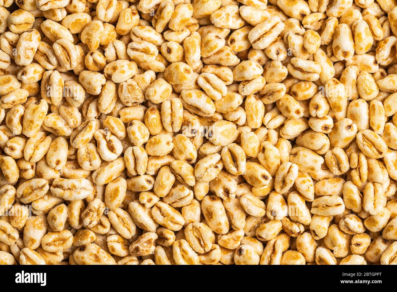puffed-wheat-covered-with-honey-pattern-of-healthy-cereals-top-view