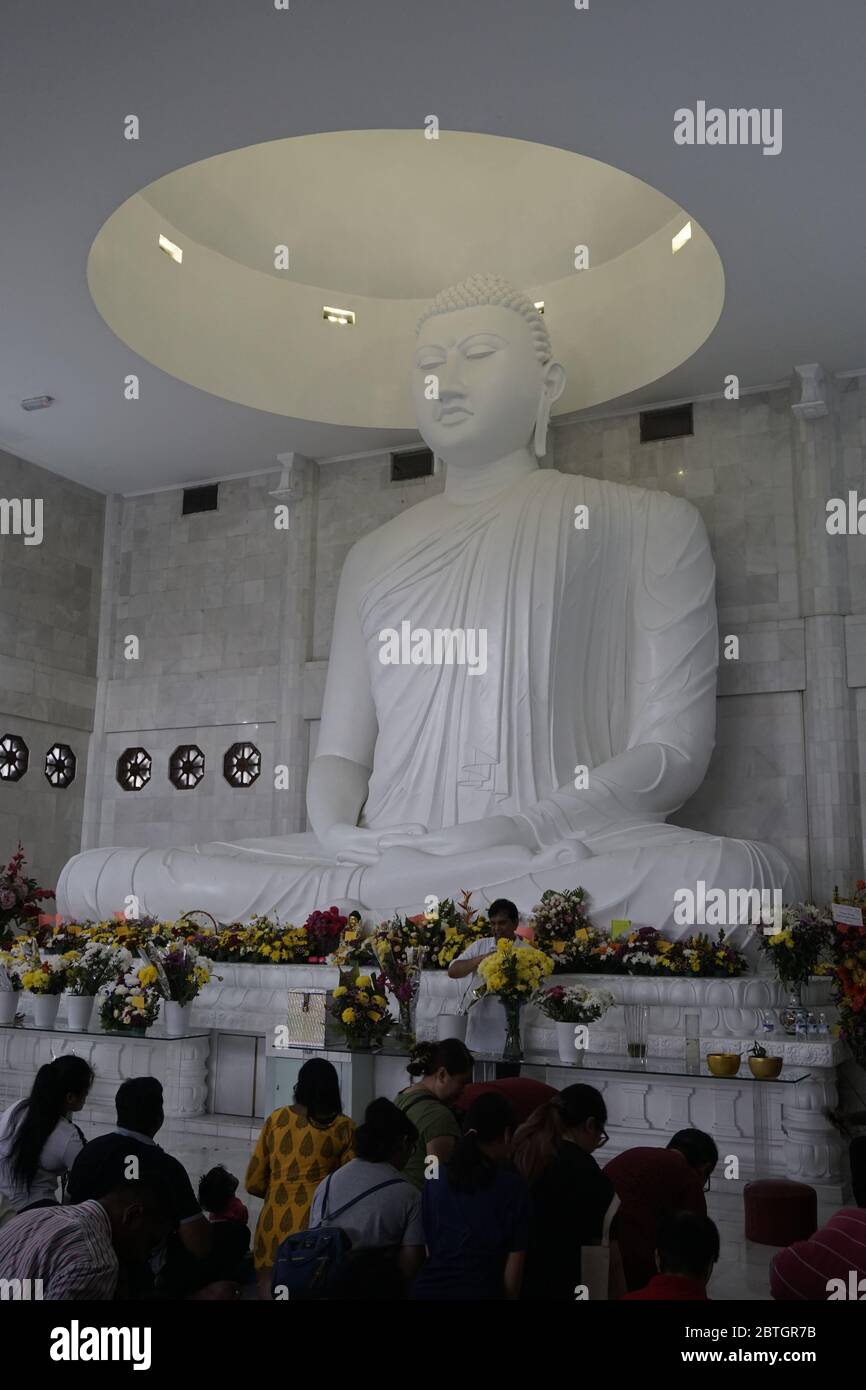 praying to Buddha Stock Photo
