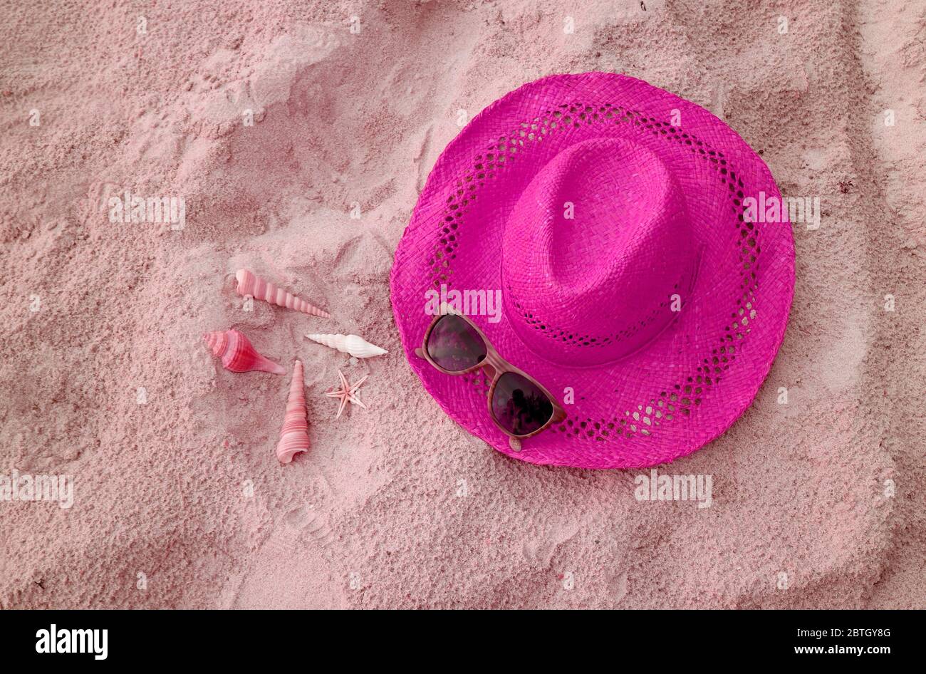Pop art shocking pink straw hat with sunglasses and little seashells on ...