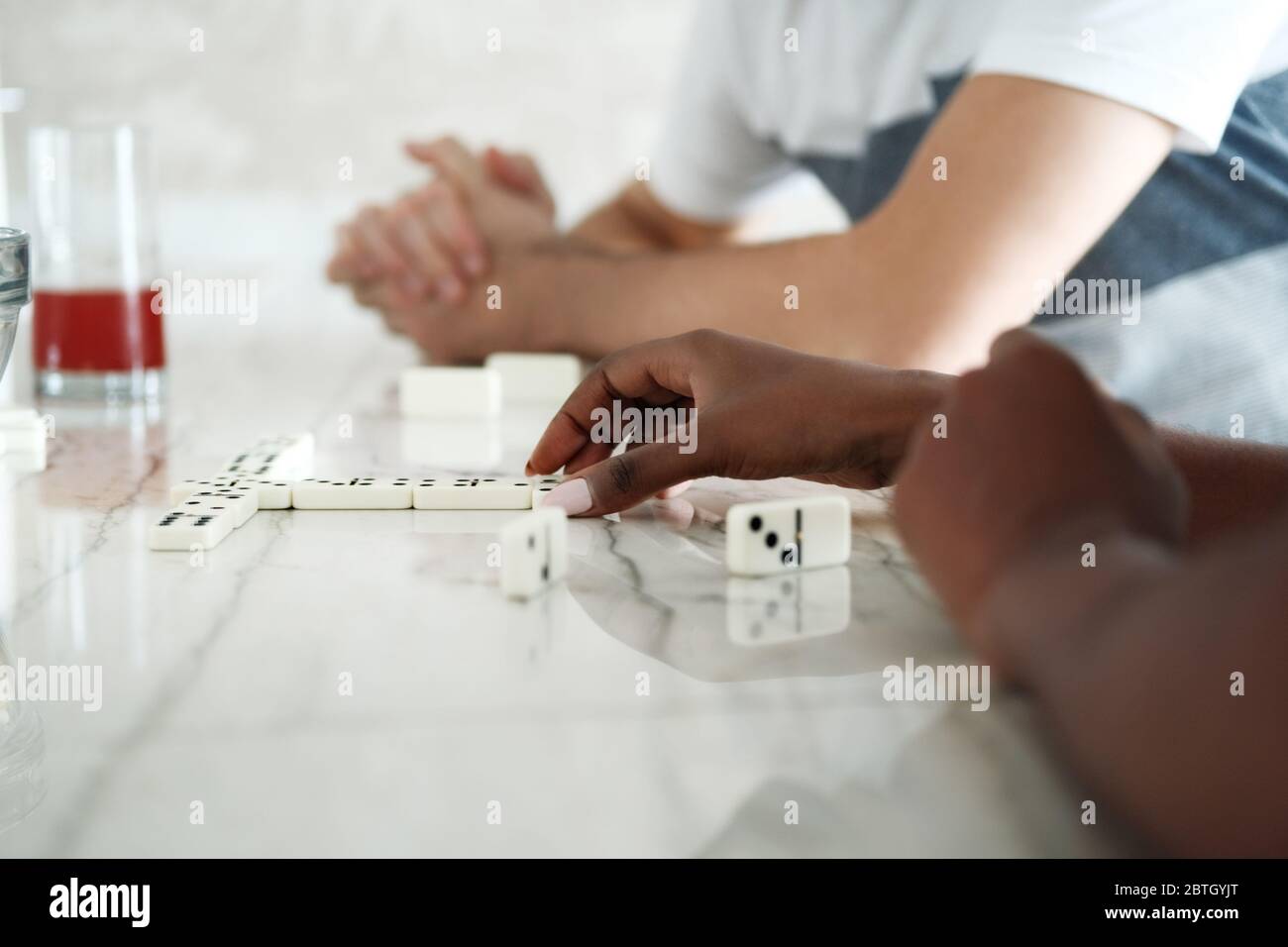 Happy Interracial Couple Having Fun Playing Domino At Home Stock Photo