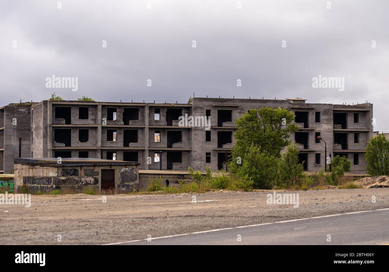 Facade of abandoned grey multi-storey soviet panel building. Russian ...