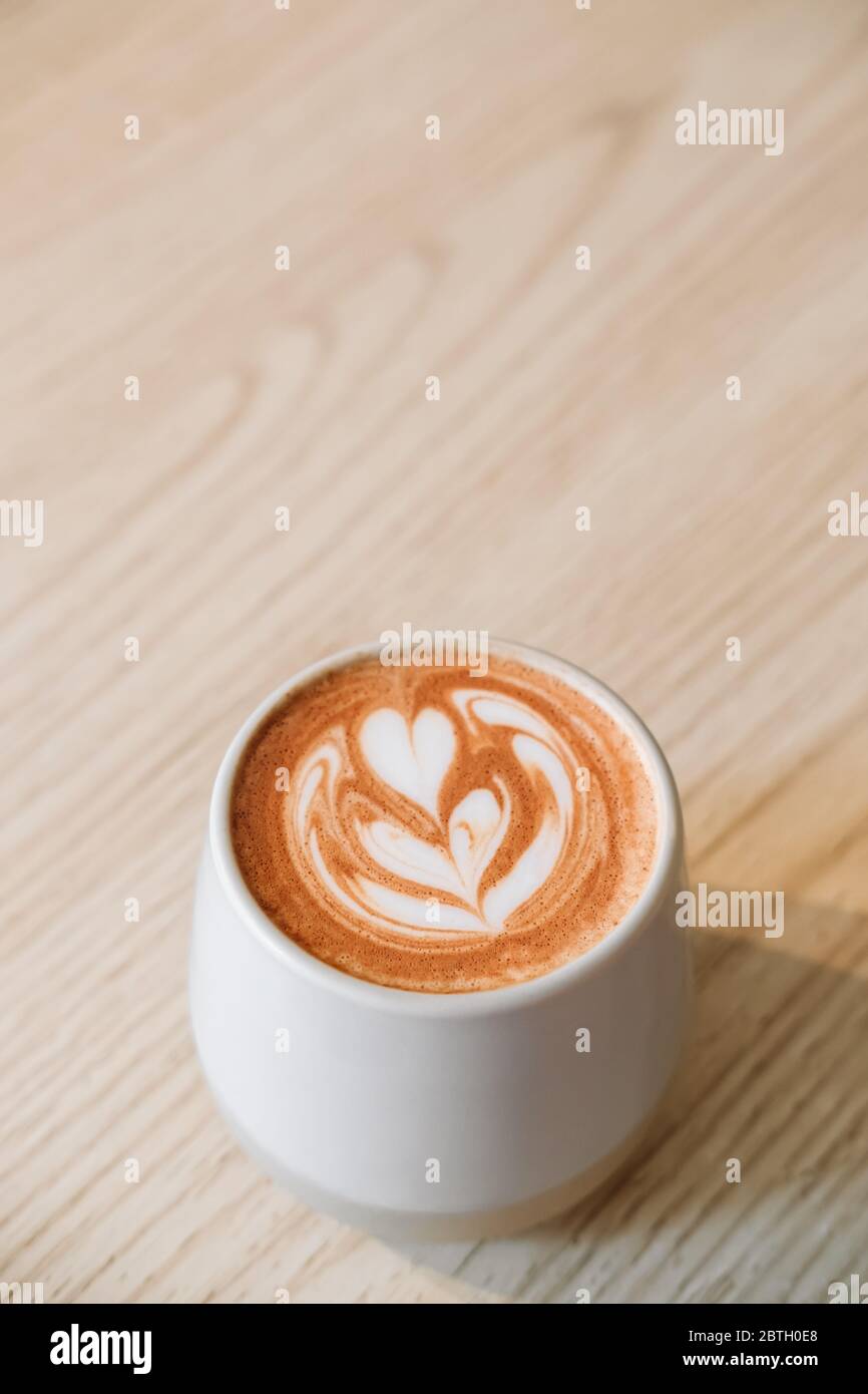 Fancy cup of coffee or hot chocolate in modern hipster cafe. Modern