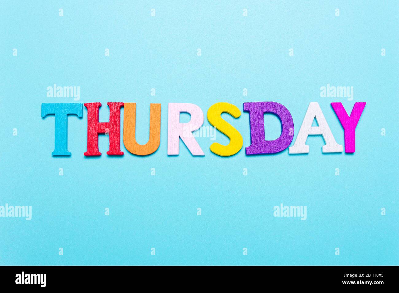 Word Thursday in colorful letters on a blue background Stock Photo