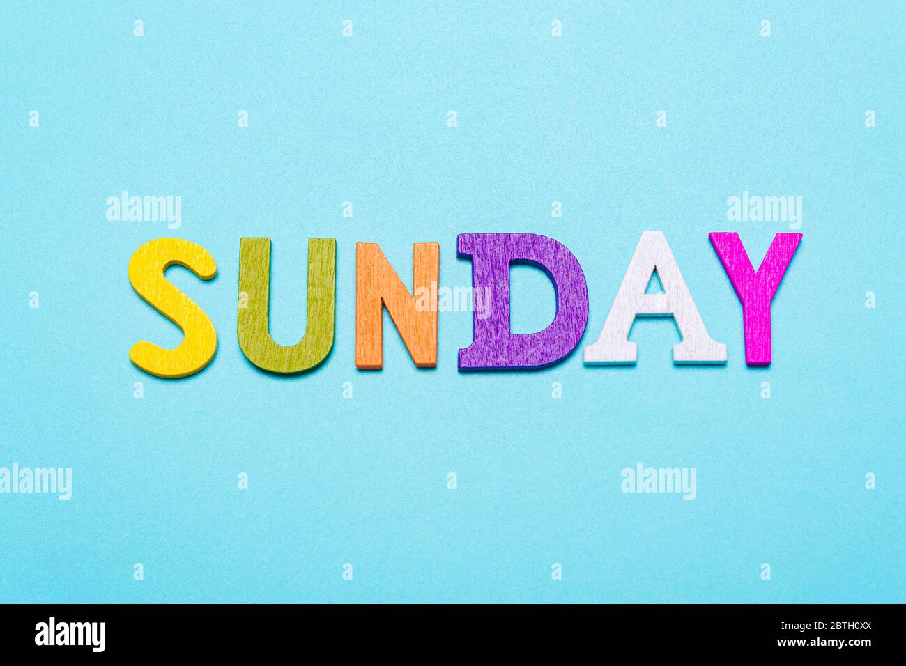 Word Sunday made of colorful letters on a blue background Stock Photo