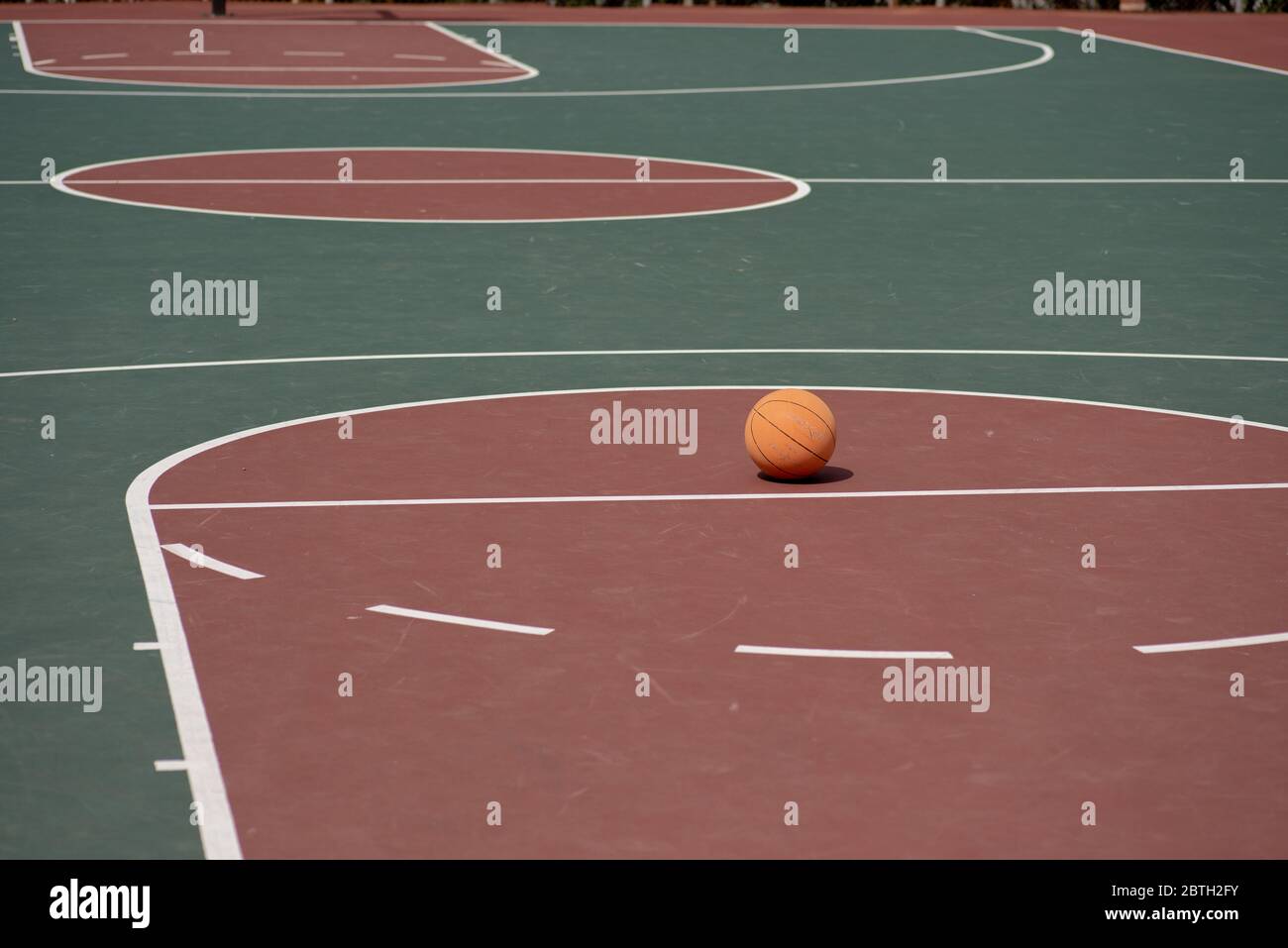 Ball placed on free throw line of empty court  Stock Photo