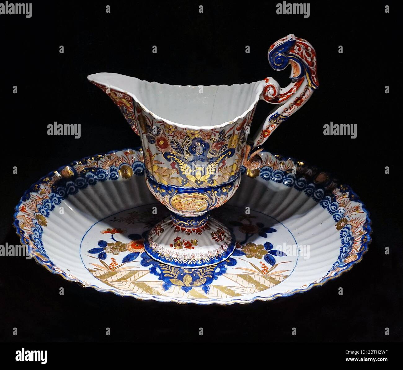 Ewer and basin set 1700-1720.Ewer and basin sets served the same purpose as wall fountains.The blue,red and gold decoration on this one is ispired by polychrome Imari porcelain from Japan. Stock Photo