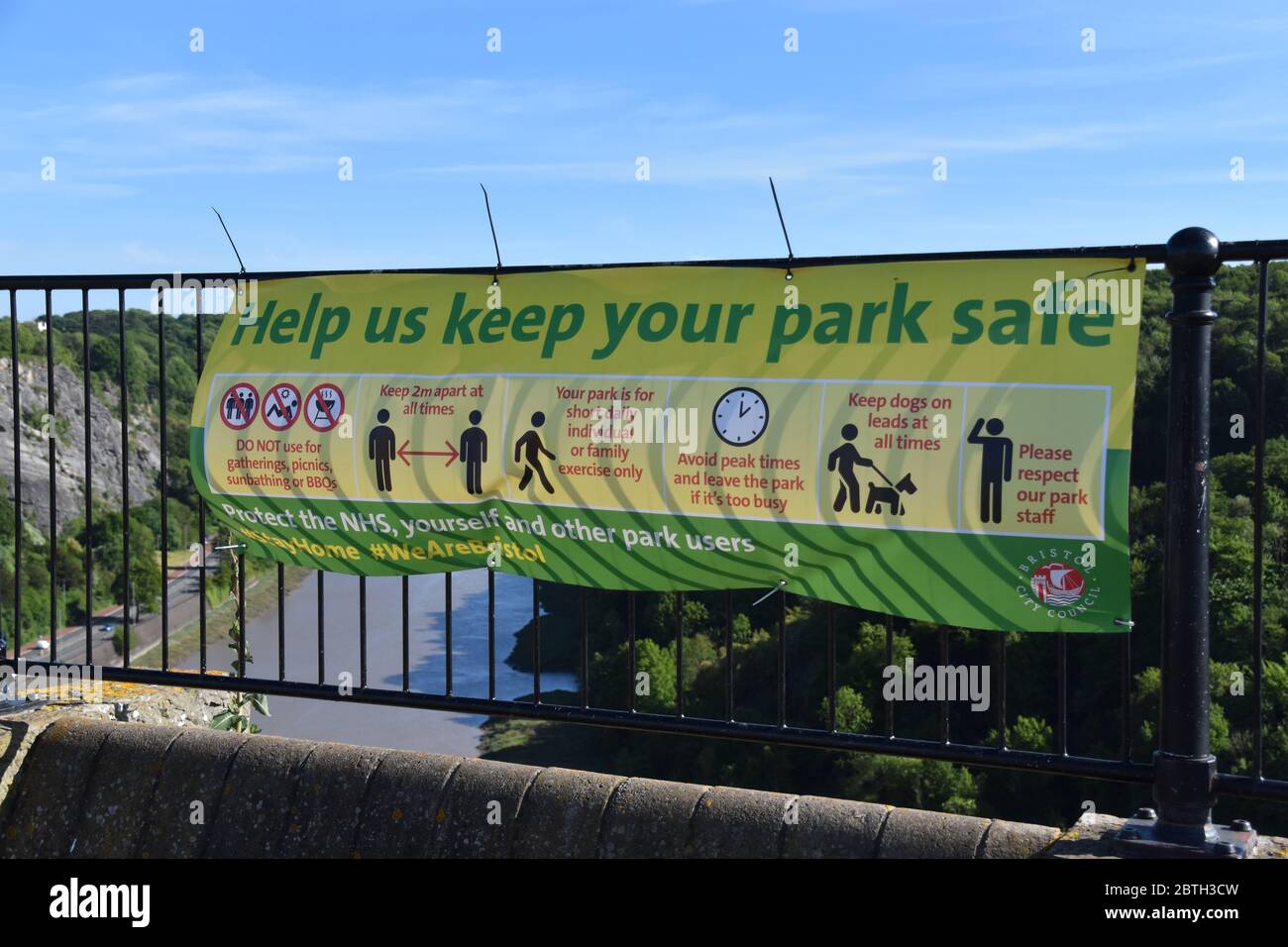A photograph of a “rules” sign at The Downs park in Clifton, Bristol – Due to the Coronavirus (Covid 19) – Clifton Suspension Bridge Background Stock Photo