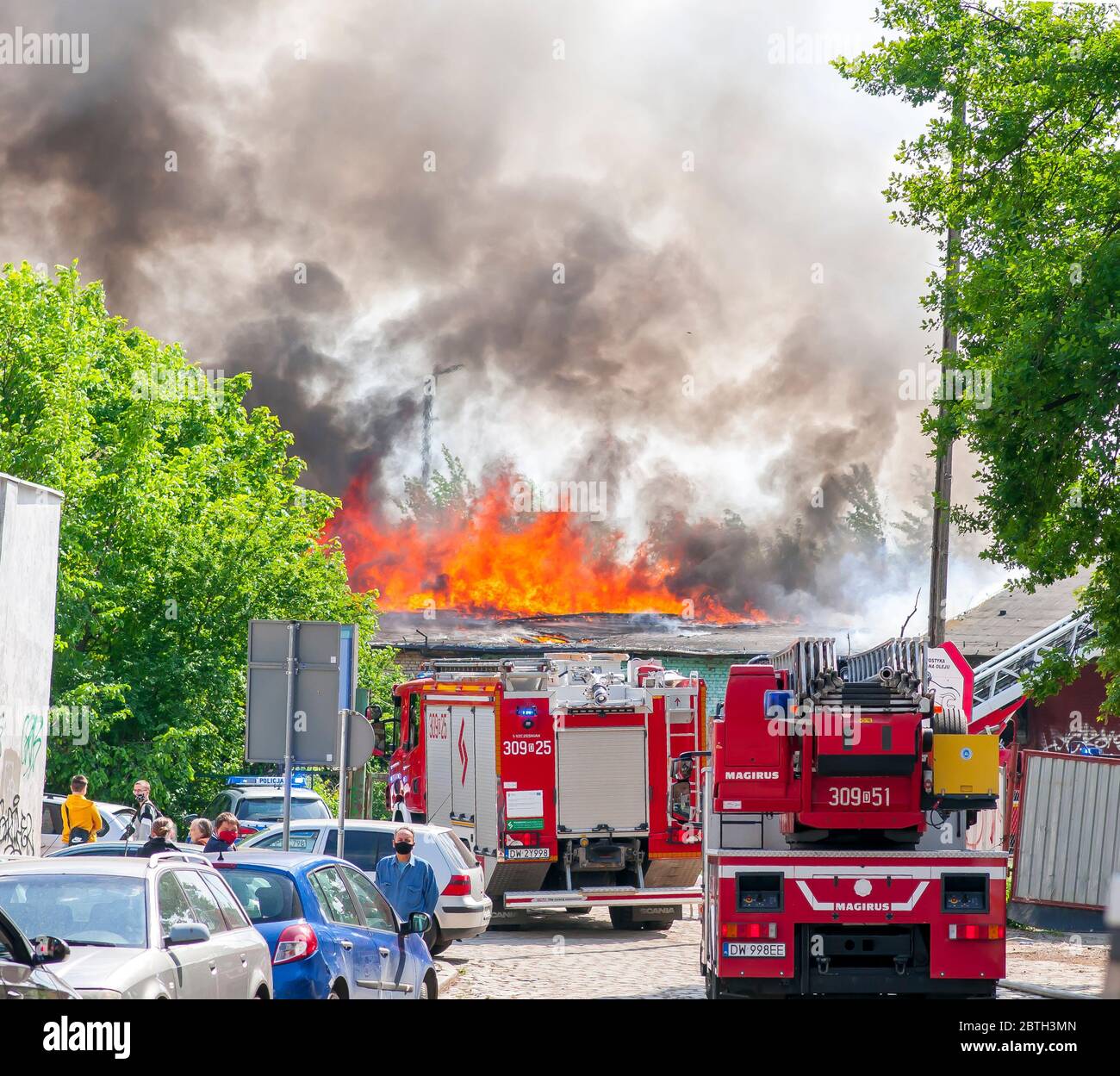 Wroclaw, Poland, May 2020. Firefighters, Fire brigade fighting fire in old abandoned building, Stock Photo