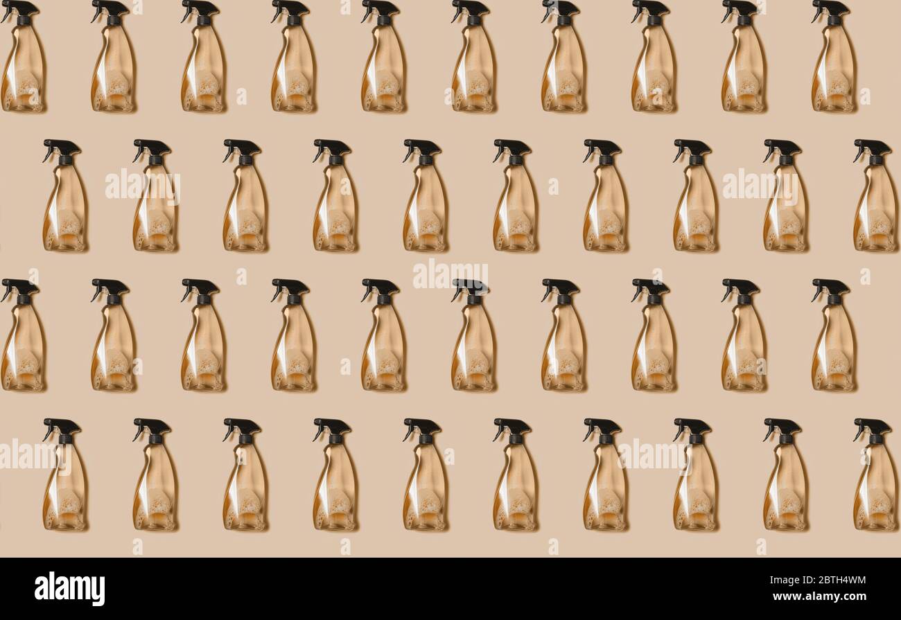 Seamless pattern of transparent plastic bottle of cleaning product, household window cleaning liquid on beige background. Creative design for packaging. Top view. Flat lay. Detergent bottle. Stock Photo