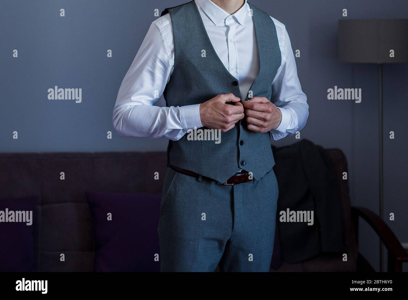 Man puts on suit jacket hi-res stock photography and images - Alamy