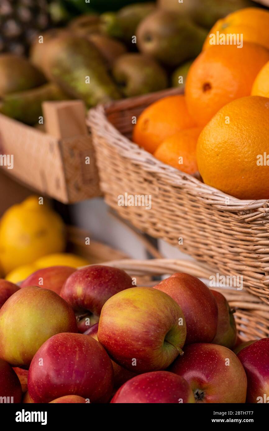 apples, oranges, and lemons with pears on a fresh fruits and vegetables stall on a market traders stand. Stock Photo