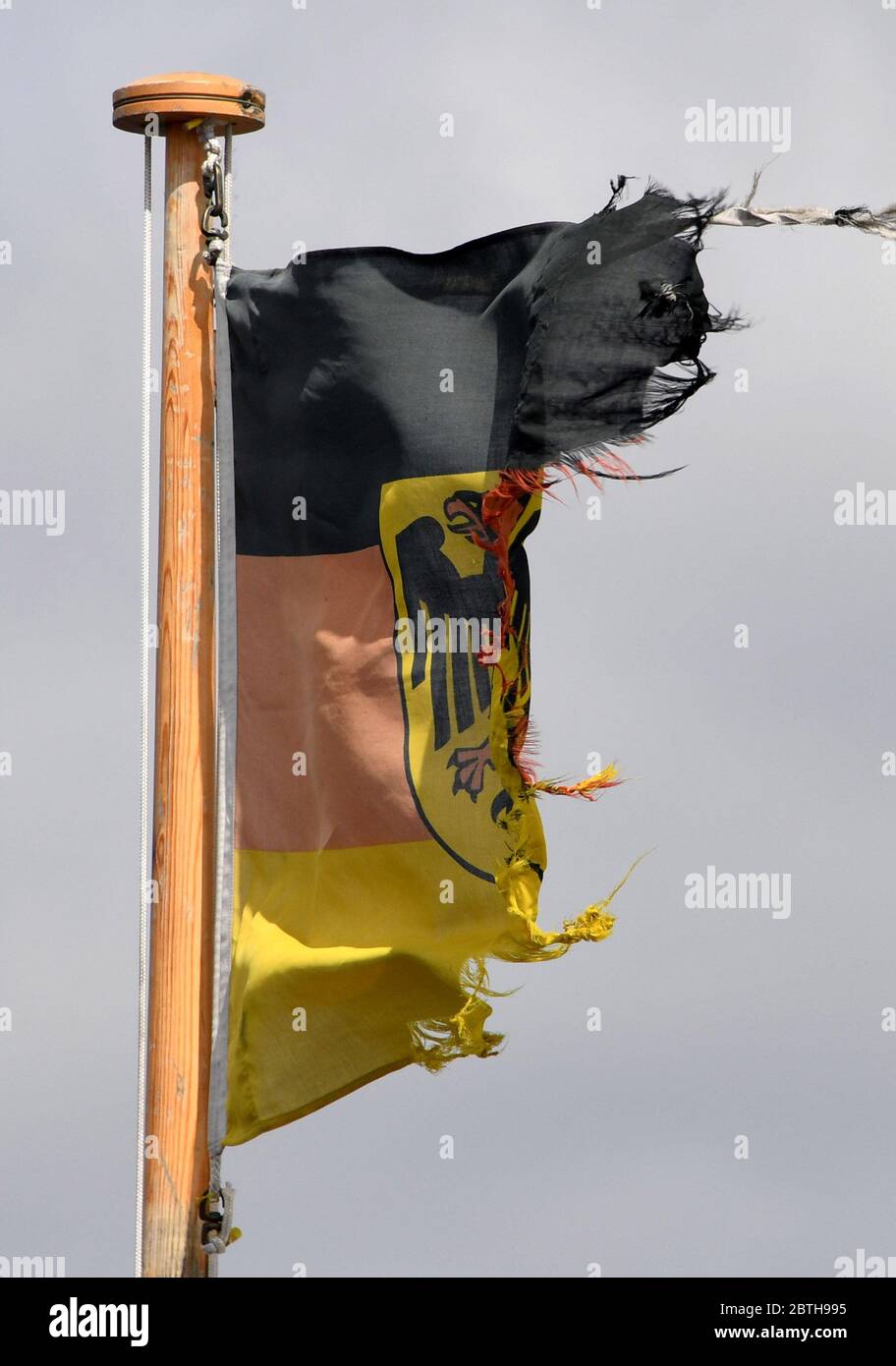 25 May 2020, Schleswig-Holstein, Eckernförde: A visibly battered service flag of the naval forces of the German Federal Armed Forces is waving on the submarine U34 in the naval port of Eckernförde. Photo: Carsten Rehder/dpa Stock Photo