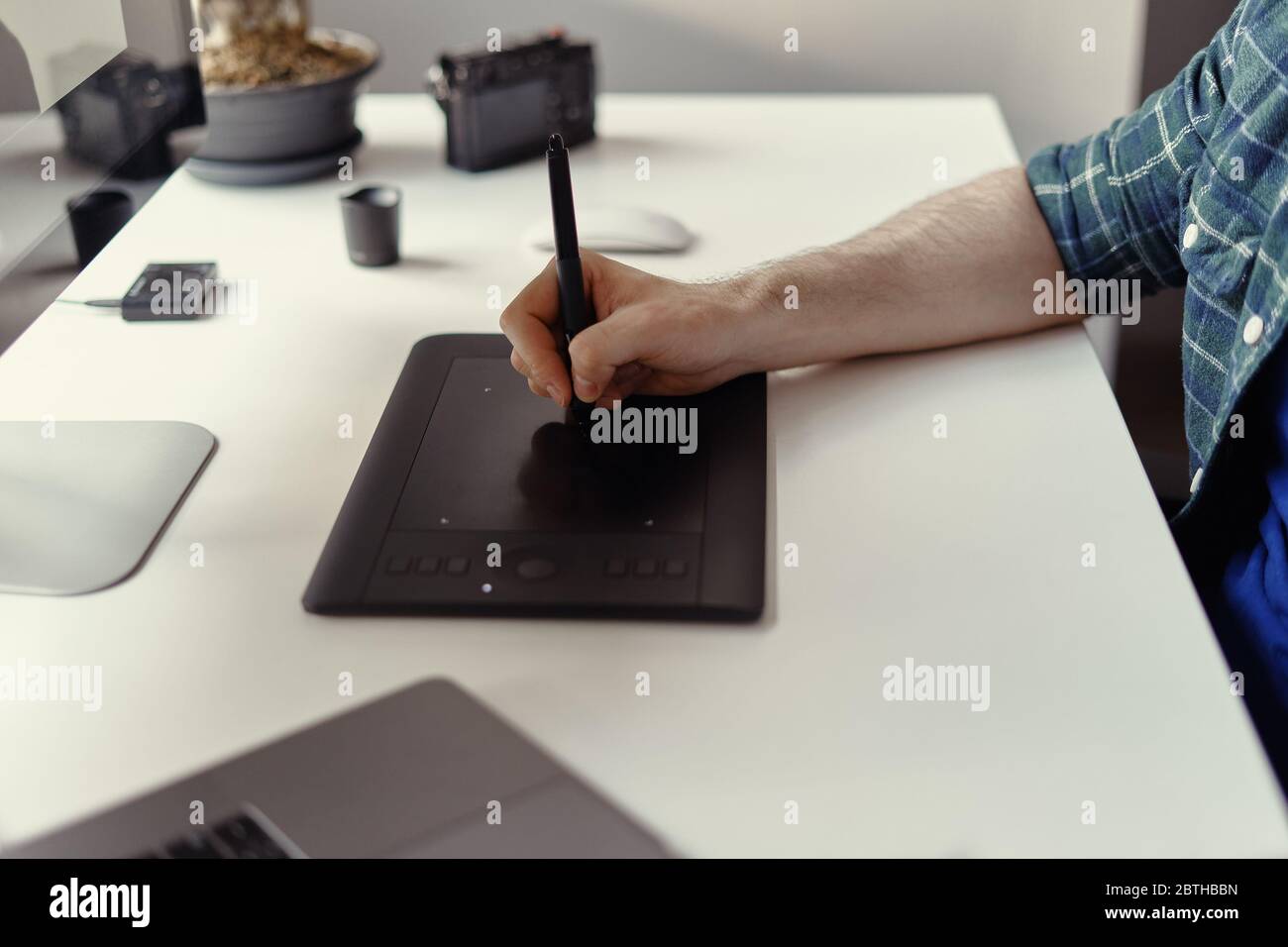 Graphic Designer working hands with interactive pen display, digital Drawing tablet and Pen. Concept of young people works mobile devices. Stock Photo