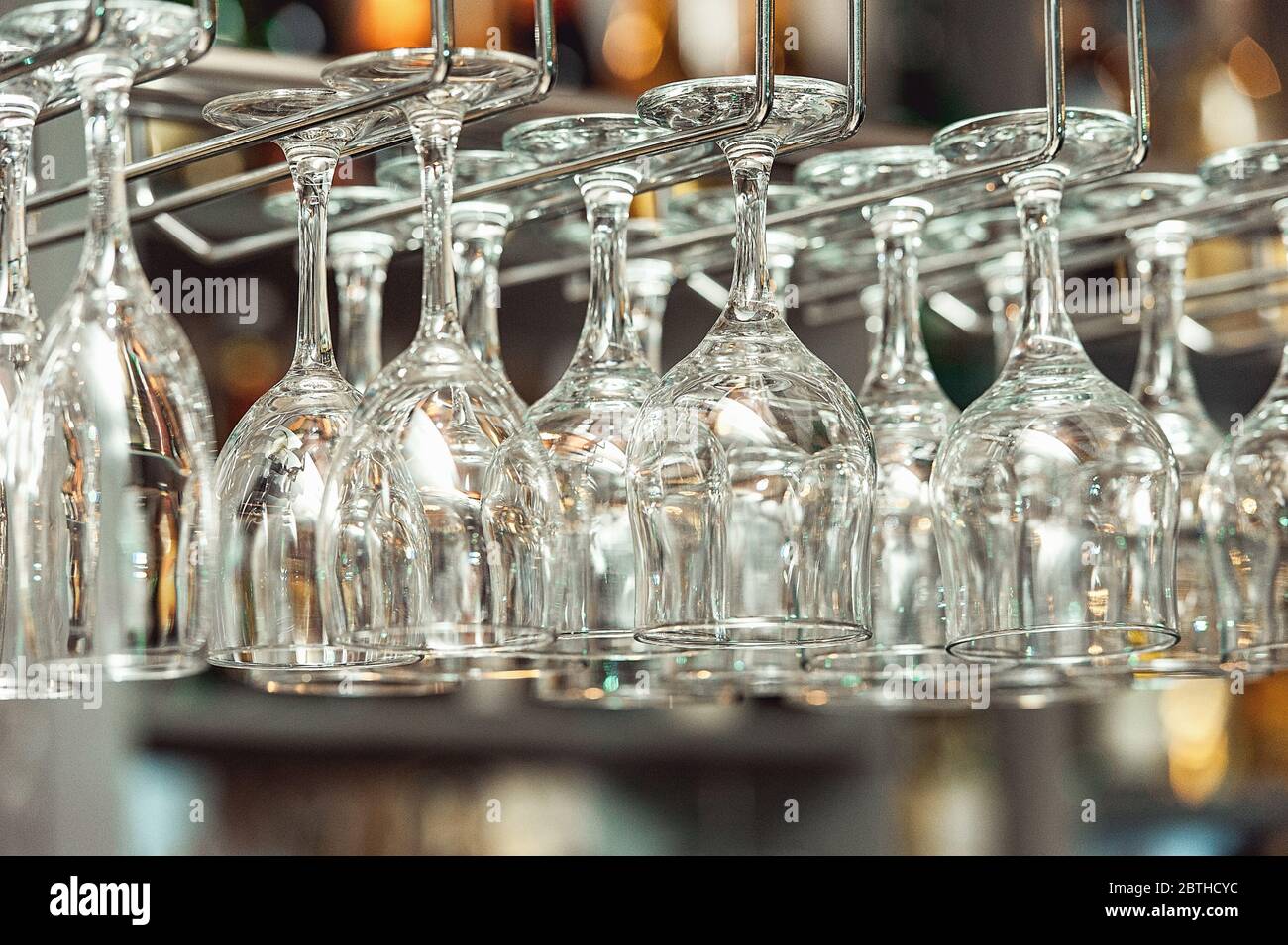 Lots of wine glasses hanging upside down Stock Photo Alamy