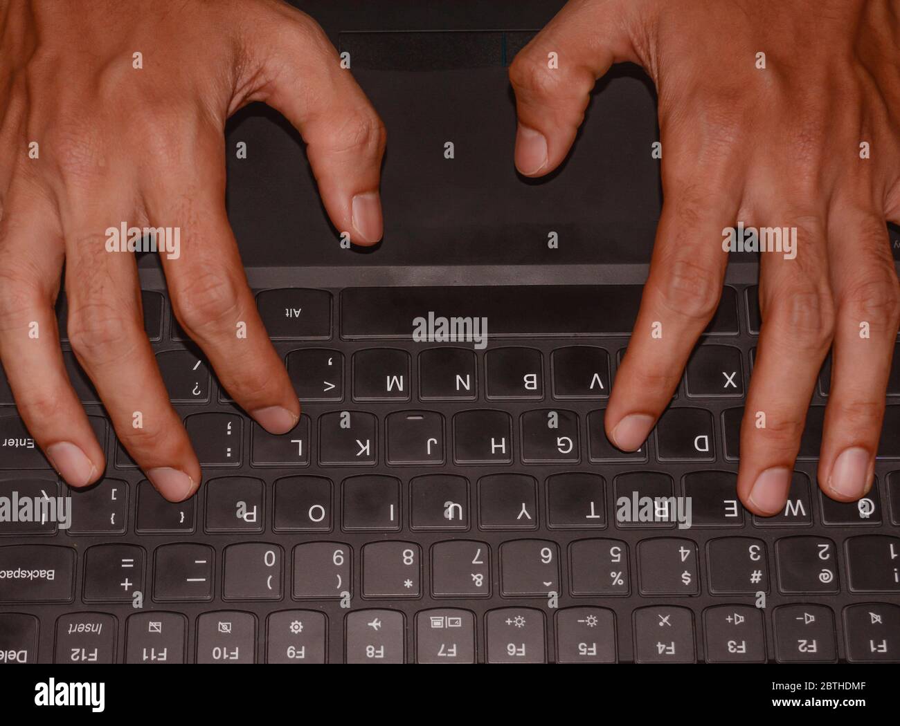 Working at home with laptop. male hands on keyboard. Stock Photo