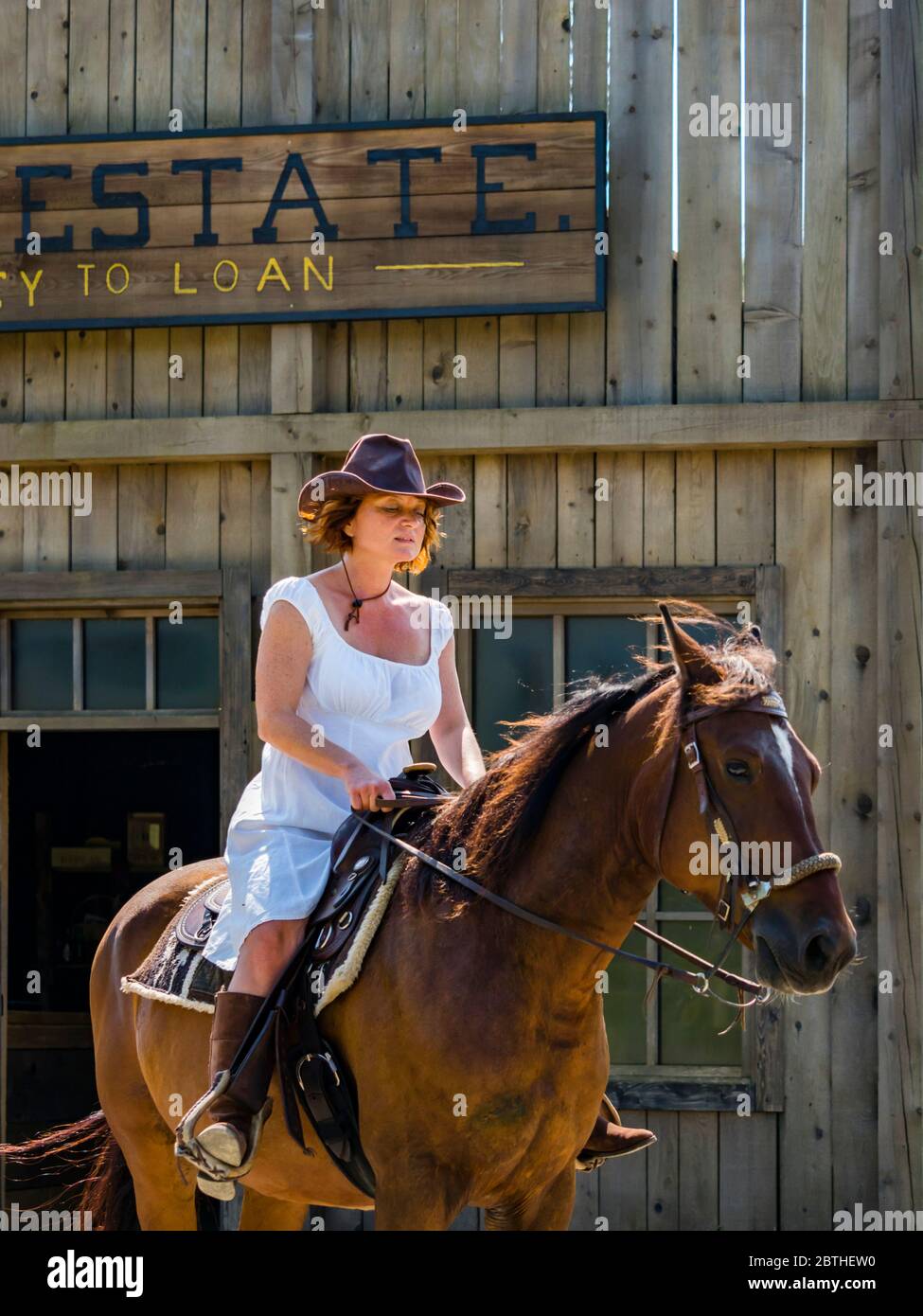 Mature woman riding horse Stock Photo