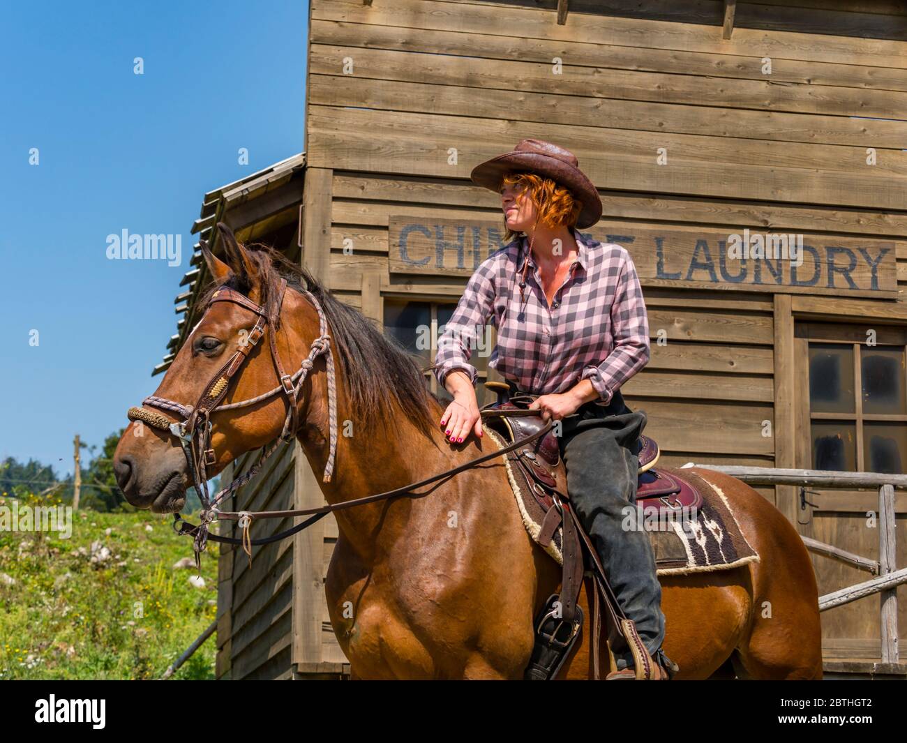 Mature woman riding horse Stock Photo