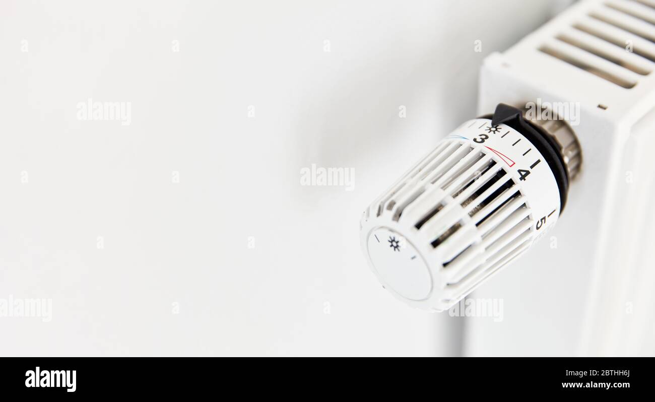 Temperature regulator with thermostat on radiator from a white heater Stock  Photo - Alamy
