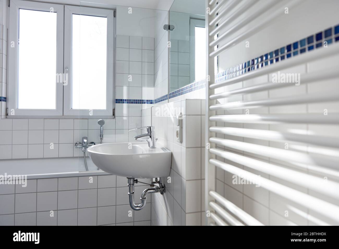 Sink Over Radiator White ceramic sink in bright bathroom with radiator and window Stock ...