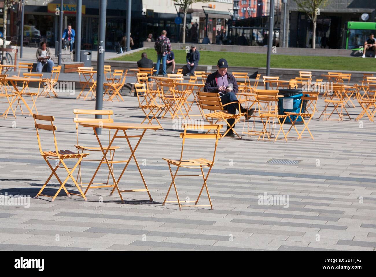 Empty tables at open-air-cafe at square during  Corona pandemic 2020 Stock Photo