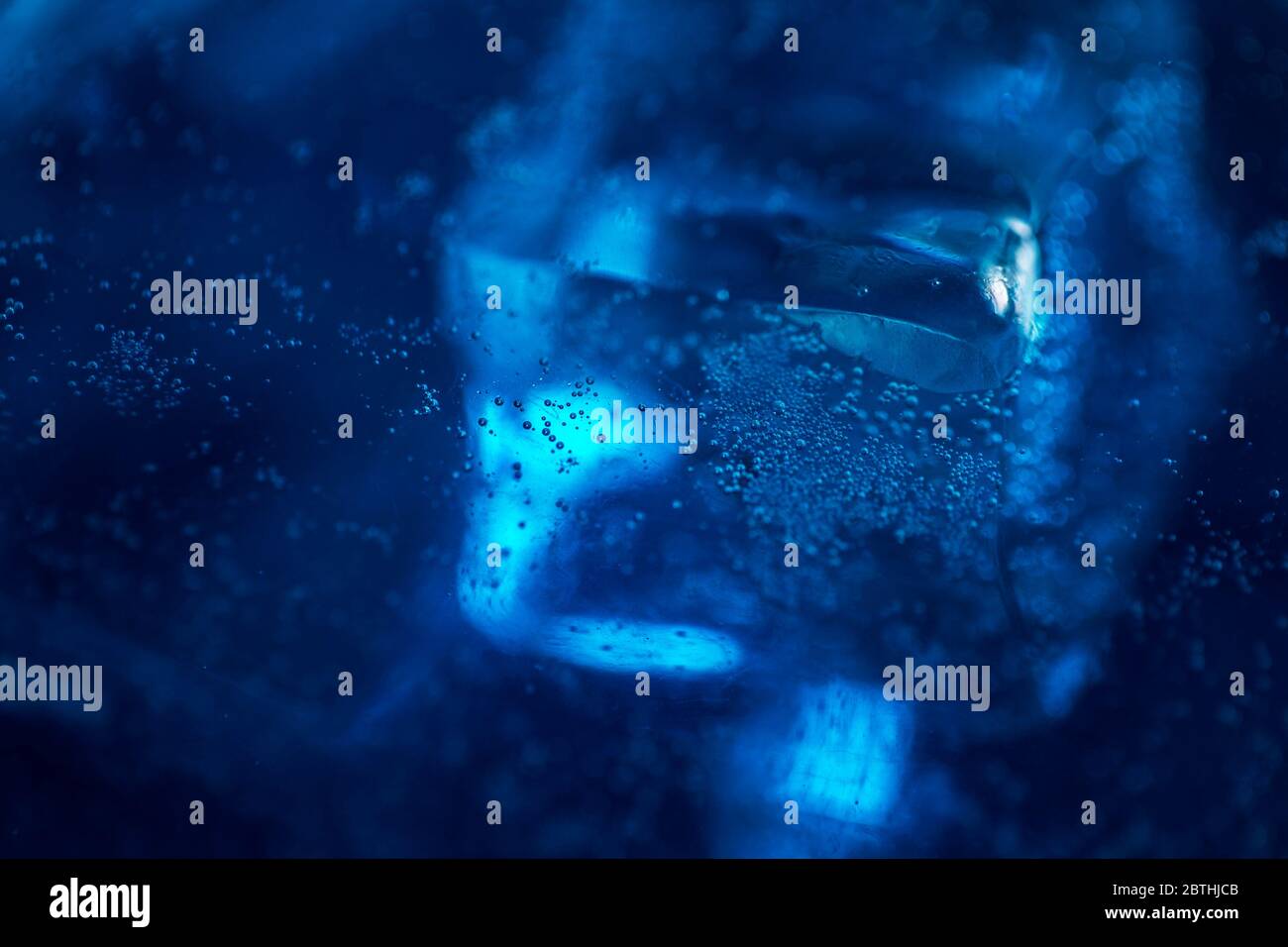 Blue sparkling water with ice cubes and bubbles macro close up Stock ...