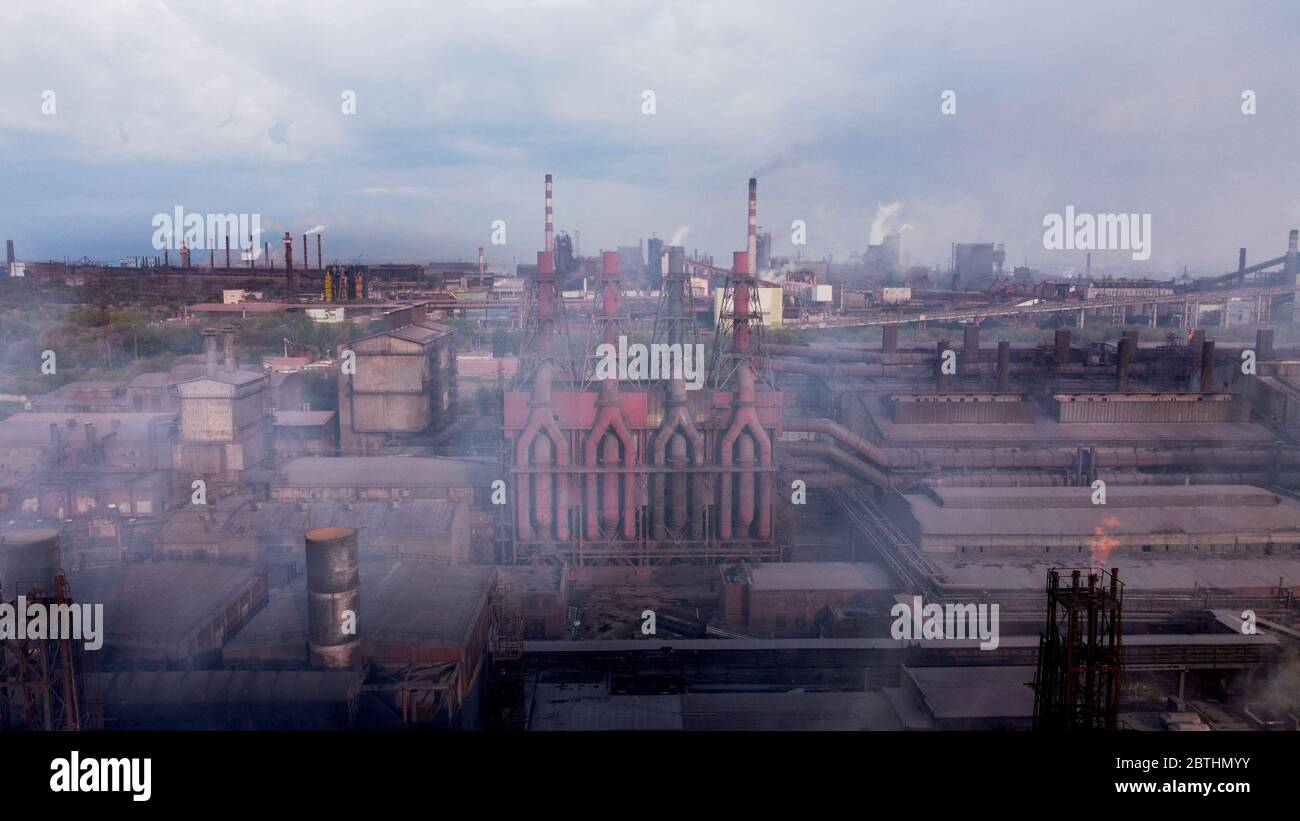 Air pollution from smoke stacks at oil refinery. chemical pipe factory smoke.  Stock Photo