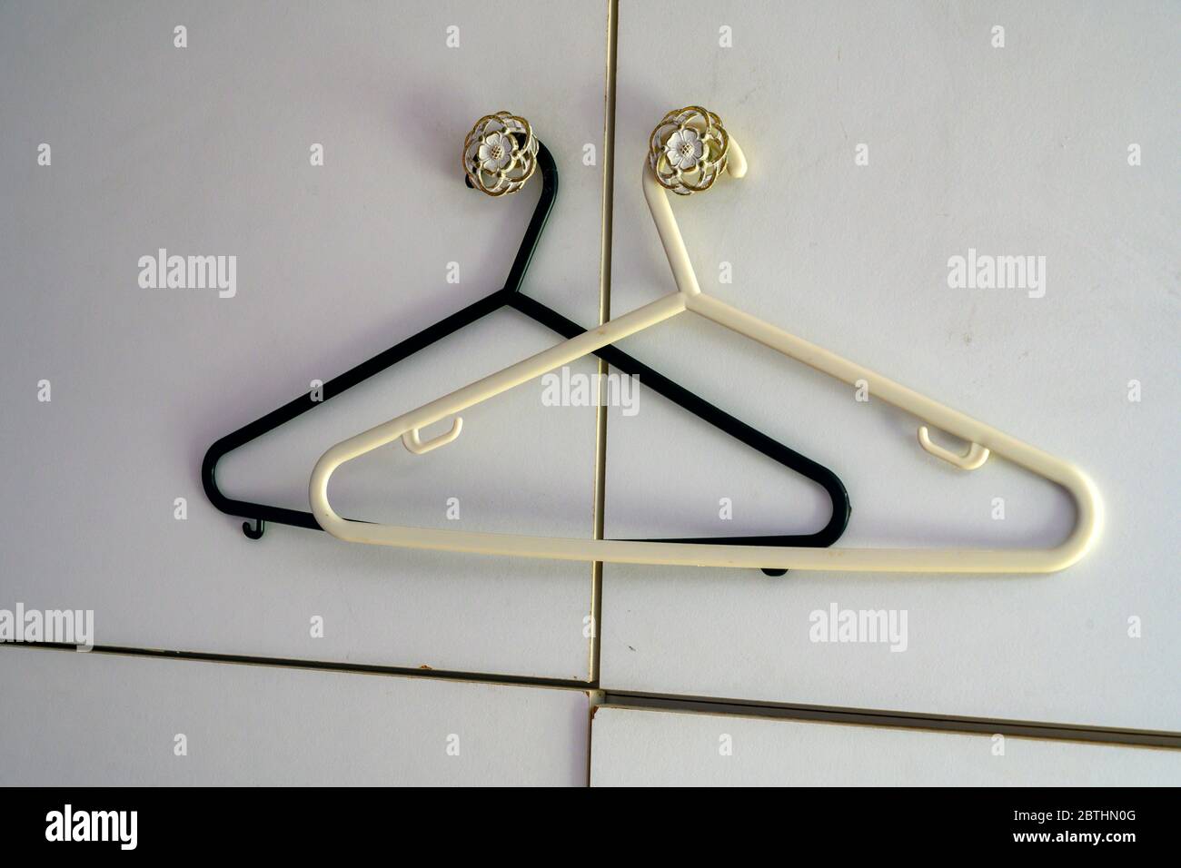 His and Hers clothes hangers Stock Photo
