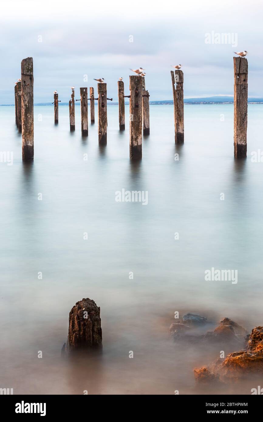 A long exposure of the jetty ruins located on the Myponga beach on the Fleurieu Peninsula South Australia on the 24th May 2020 Stock Photo