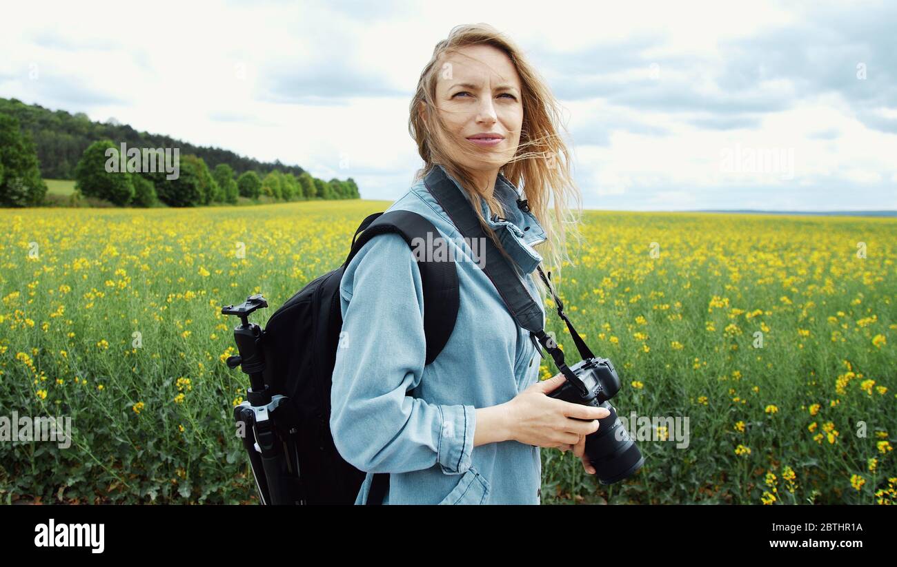 Photographer looking around, side view Stock Photo