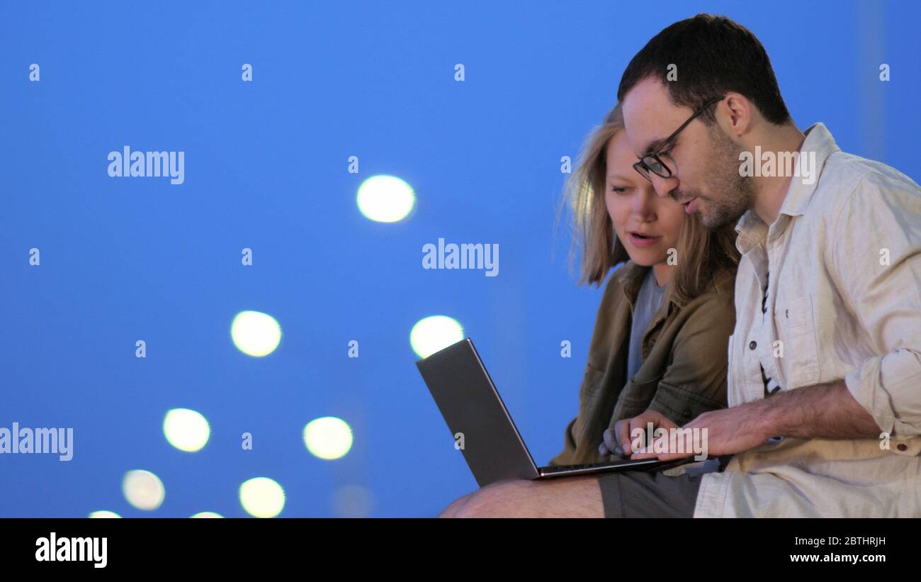 Male And Female College Students Working On Laptop In Library Stock Photo