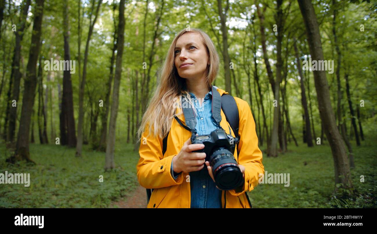 Photographer admiring spring leafy forest Stock Photo