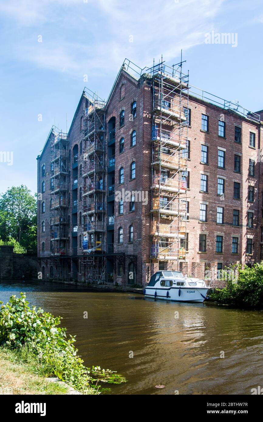 Image showcasing A former factory now converted into canalside apartments Stock Photo ...