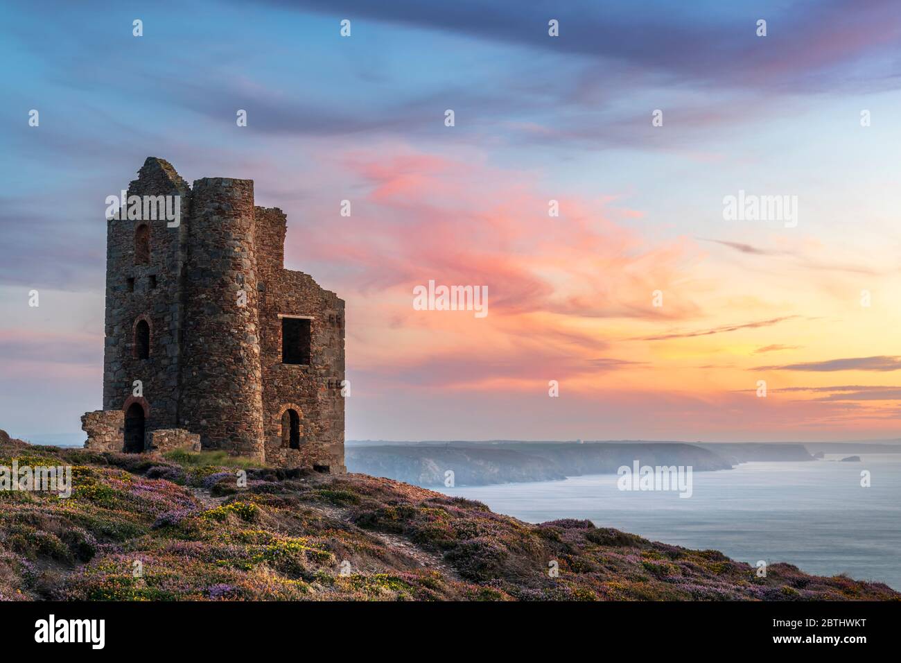 After a hot and sunny day in Cornwall the wind picks up as the sun sets over Wheal Coates at St. Agnes Beacon at the start of the August Bank Holiday Stock Photo