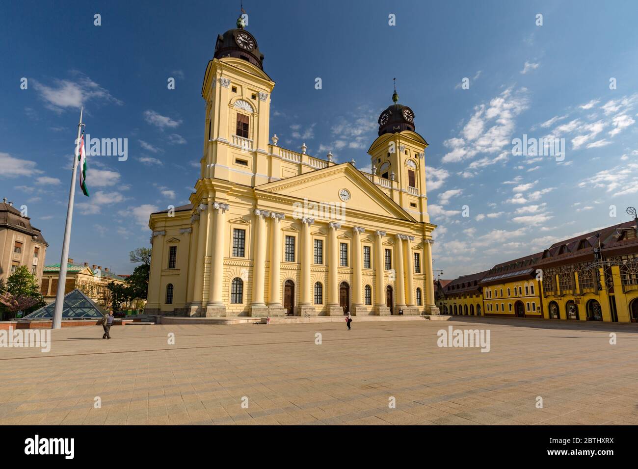 Reformed Great Church in Debrecen city, Hungary. Old city center with statues and flower garden Stock Photo