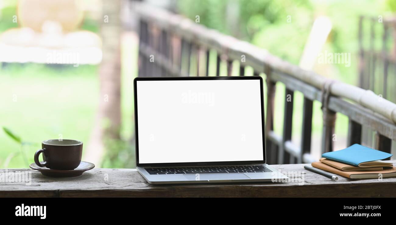 Photo of Computer laptop with white blank screen putting on wooden long ...