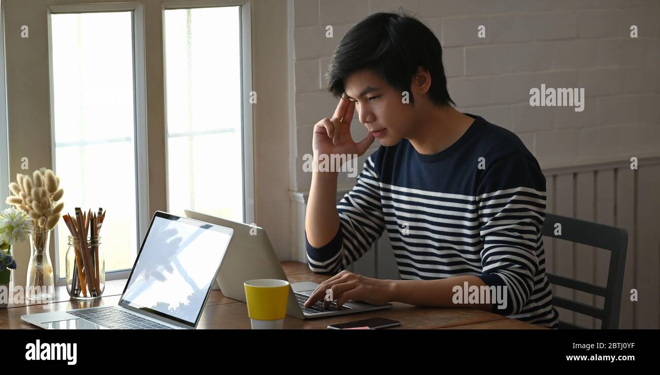 Creative man keep hand on head while looking into computer laptop that ...