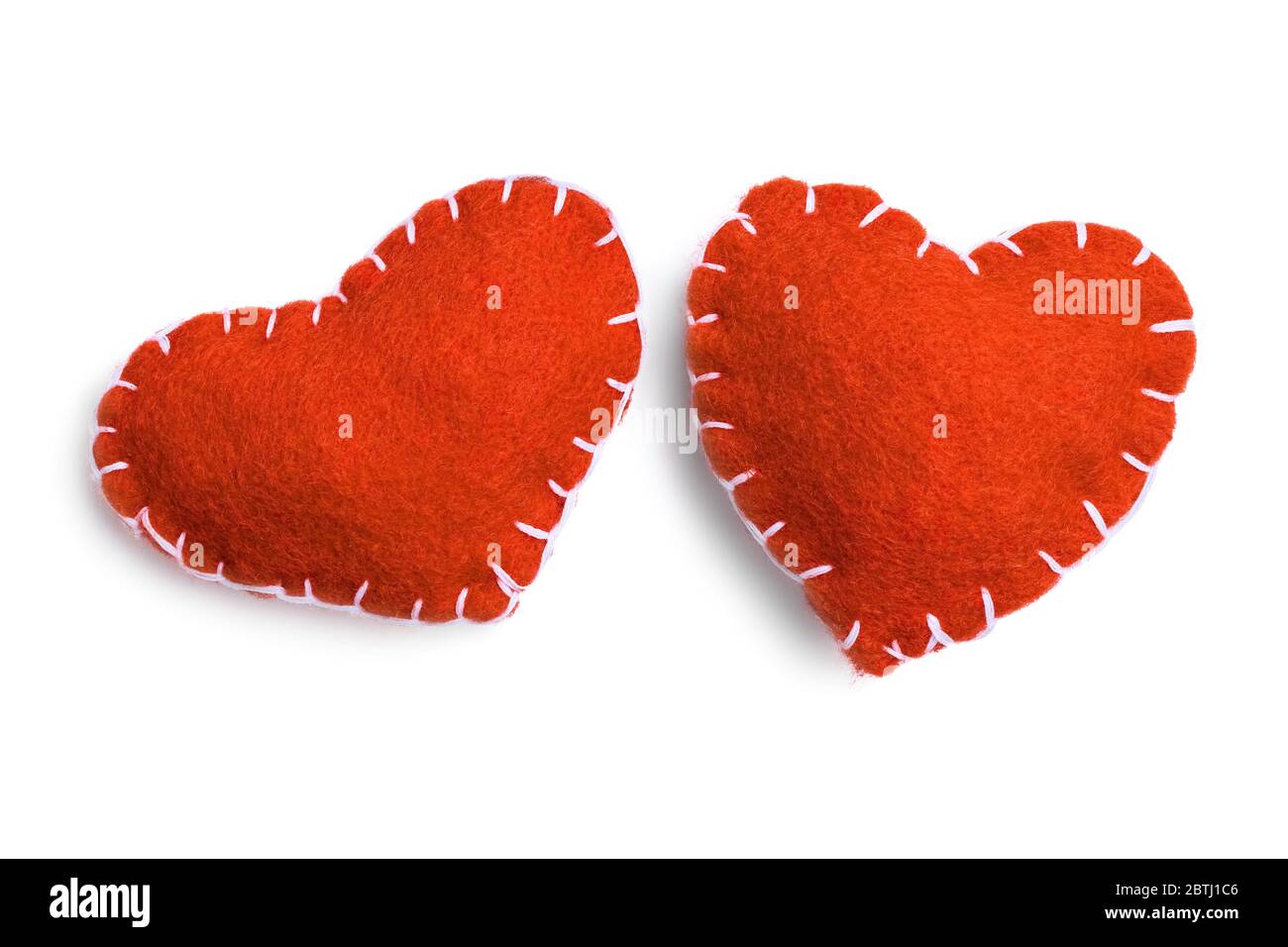 Two red handmade felt hearts isolated on a white background Stock Photo ...