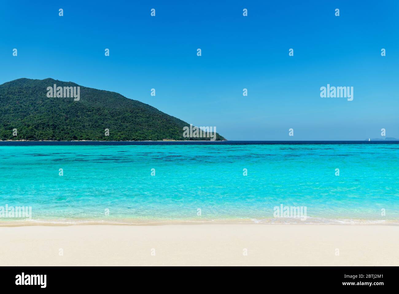 Turquoise clear sea and white sand beach on tropical island. Summer vacation, travel, nature background concept Stock Photo